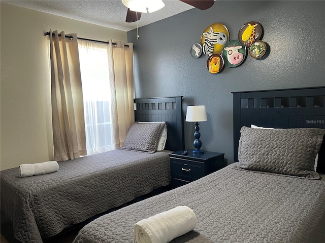 2494 Sweetwater Club Cir Unit 55, Kissimmee, FL 34746 - bedroom with a textured wall, a textured ceiling, and ceiling fan