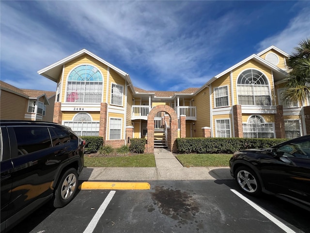 2494 Sweetwater Club Cir Unit 55, Kissimmee, FL 34746 - view of building exterior with uncovered parking