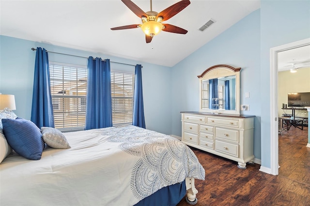 bedroom with baseboards, visible vents, a ceiling fan, lofted ceiling, and dark wood-type flooring