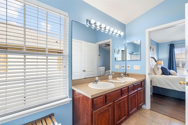 full bathroom featuring a sink, connected bathroom, and tile patterned floors