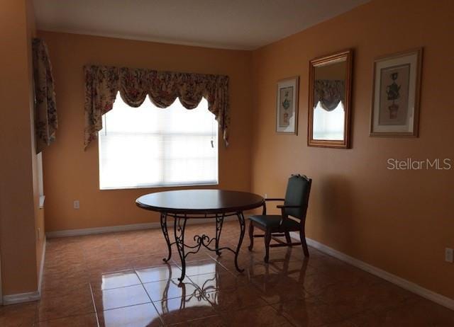 dining room with baseboards and tile patterned floors