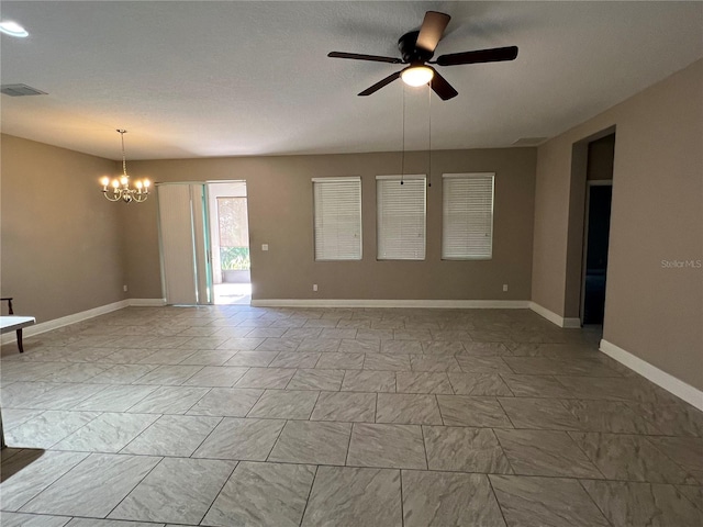 unfurnished room with ceiling fan with notable chandelier, marble finish floor, visible vents, and baseboards