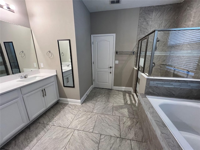 bathroom featuring marble finish floor, a garden tub, visible vents, a stall shower, and vanity