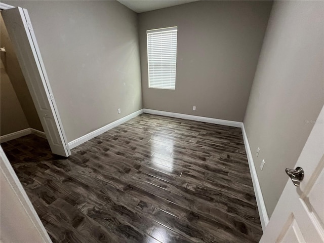 unfurnished bedroom featuring dark wood-style floors and baseboards