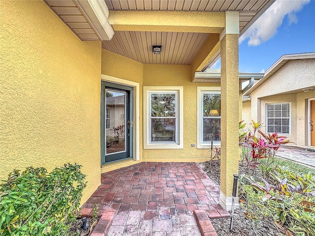 entrance to property featuring stucco siding