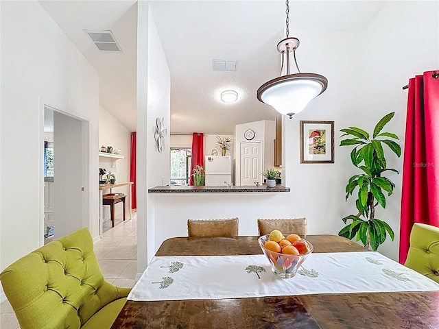 tiled dining room with visible vents