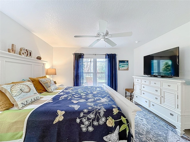 bedroom with ceiling fan and a textured ceiling