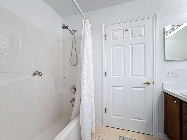 full bath featuring a textured ceiling, shower / tub combo, vanity, and tile patterned floors