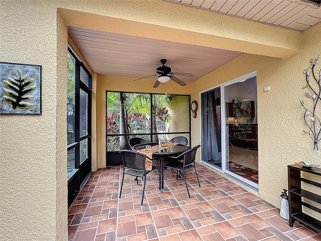 sunroom featuring ceiling fan