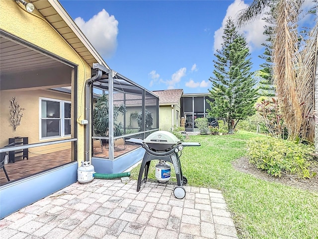 view of patio / terrace with area for grilling and a lanai