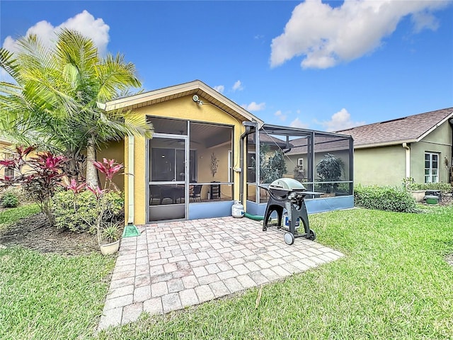 back of house with glass enclosure, stucco siding, a lawn, and a patio