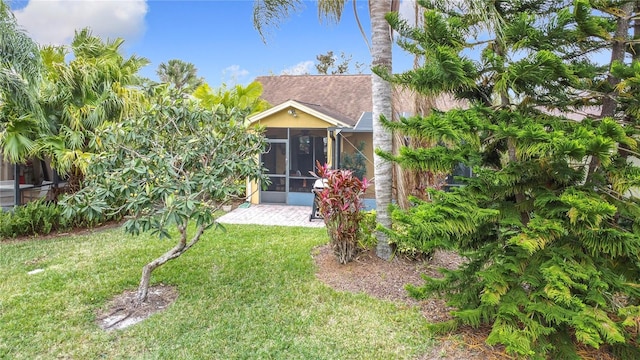 rear view of property with a patio area and a yard