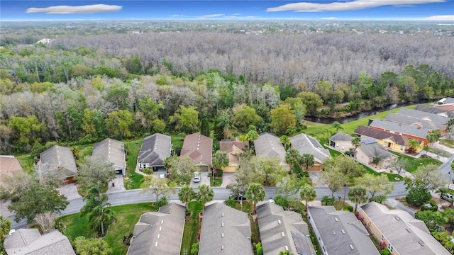 drone / aerial view with a residential view and a wooded view