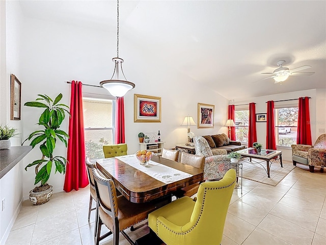 dining area featuring light tile patterned floors, ceiling fan, and vaulted ceiling