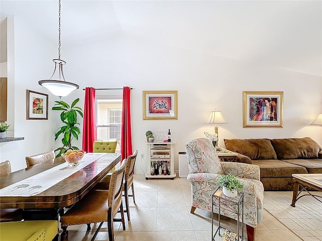 dining space with light tile patterned flooring and vaulted ceiling