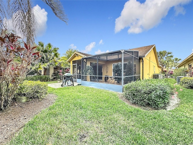 rear view of property featuring a yard and a patio