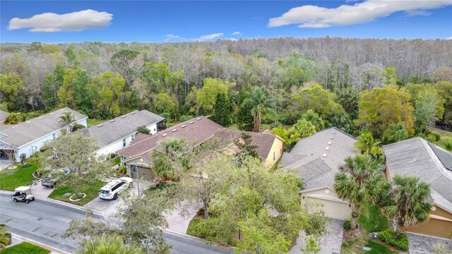 birds eye view of property featuring a wooded view and a residential view