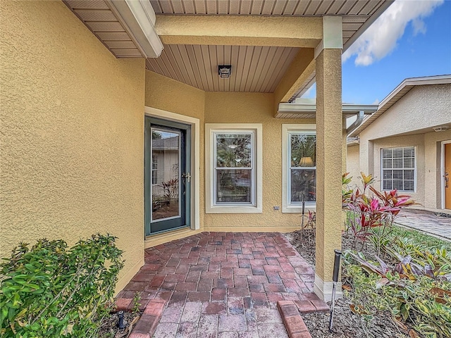 view of exterior entry with stucco siding