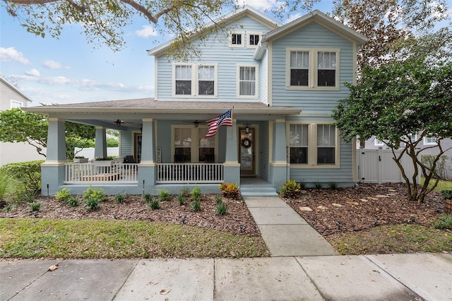 view of front of house with a porch, fence, and a ceiling fan