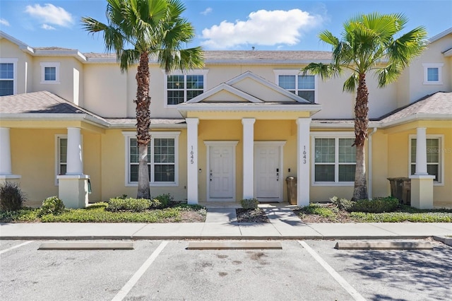 view of front of house featuring uncovered parking and stucco siding