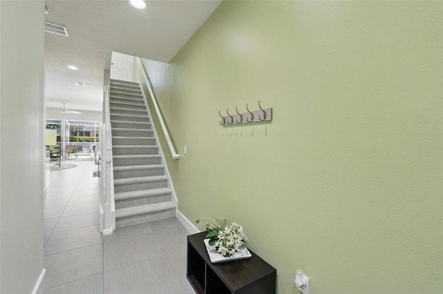 stairs with tile patterned flooring, visible vents, baseboards, and recessed lighting