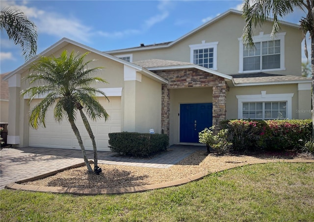 traditional-style house featuring stone siding, stucco siding, an attached garage, and driveway