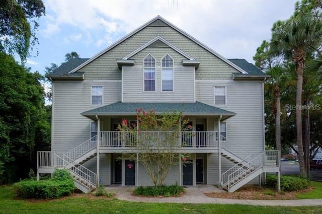 rear view of property with stairs