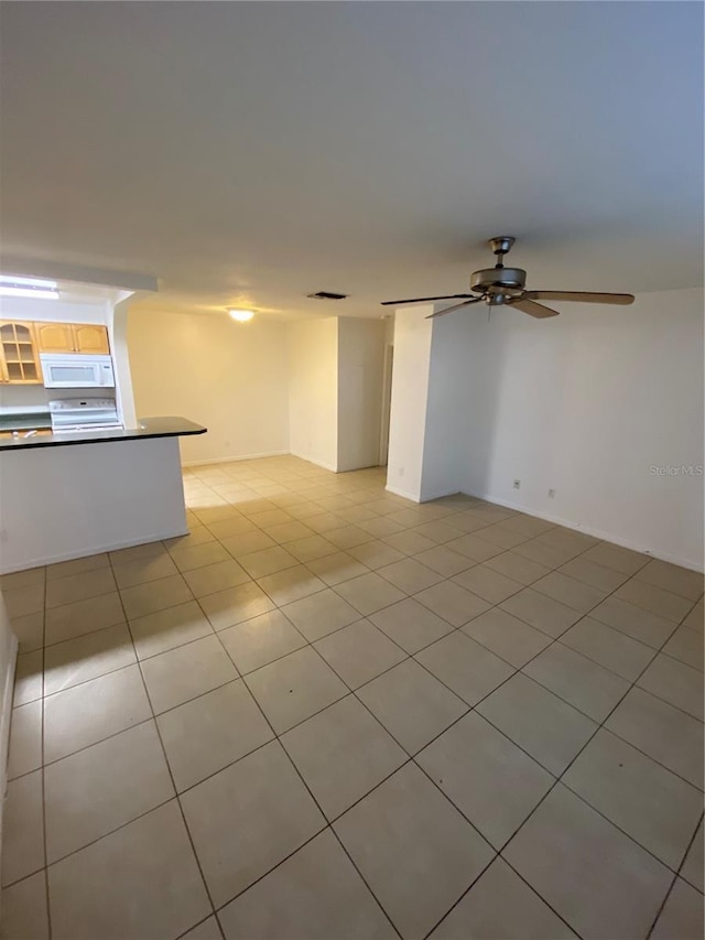 empty room with light tile patterned floors and ceiling fan