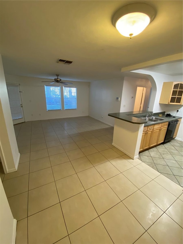 kitchen featuring light tile patterned floors, visible vents, dark countertops, ceiling fan, and open floor plan