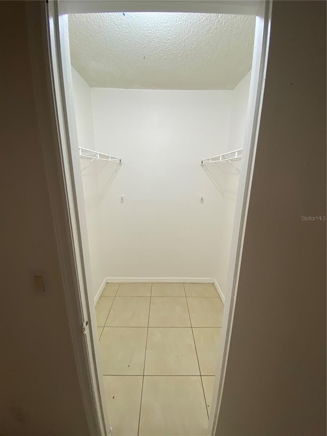 spacious closet featuring tile patterned flooring