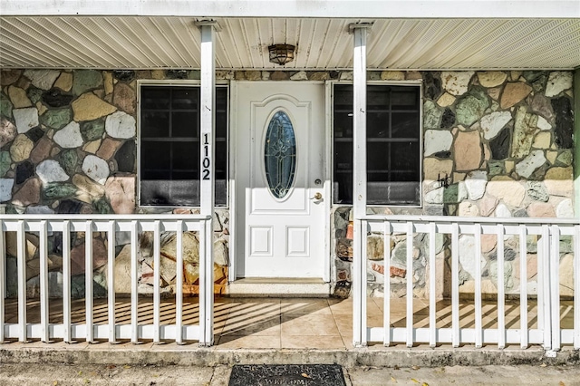 view of exterior entry featuring stone siding