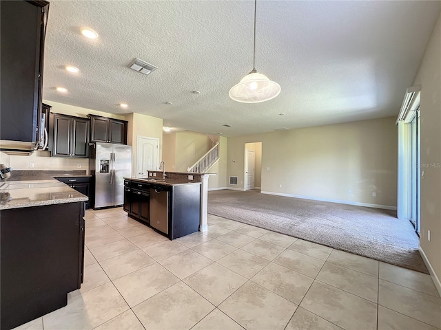 kitchen featuring light colored carpet, visible vents, appliances with stainless steel finishes, open floor plan, and a sink