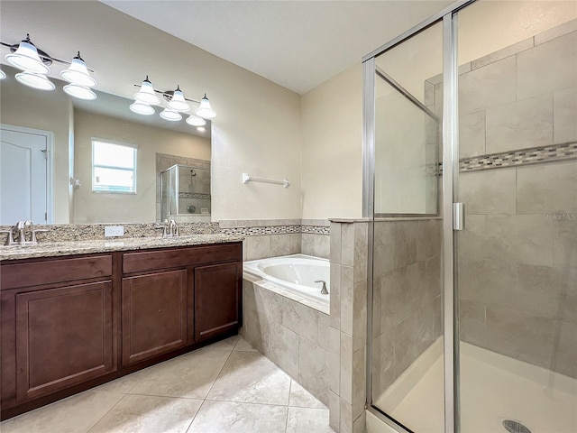 full bath with double vanity, tile patterned floors, a sink, a shower stall, and a bath