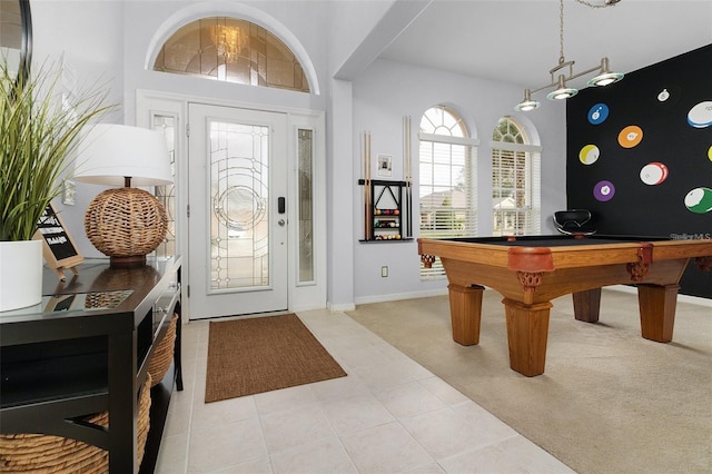 foyer featuring pool table, light tile patterned flooring, light colored carpet, and baseboards