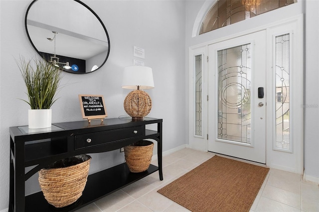 foyer entrance with tile patterned floors and baseboards