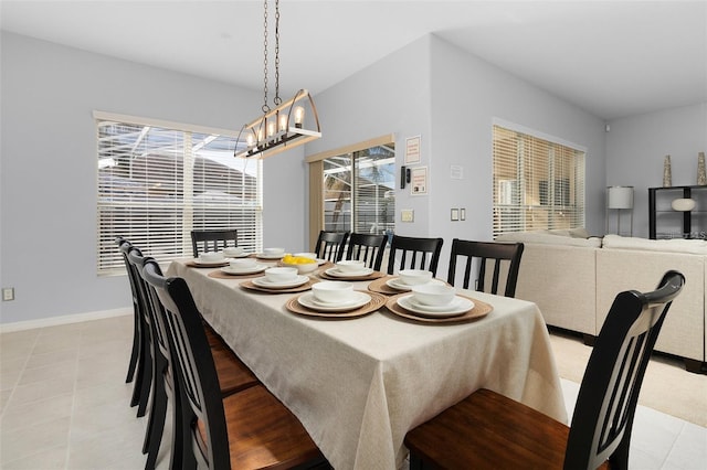 dining space with an inviting chandelier and baseboards