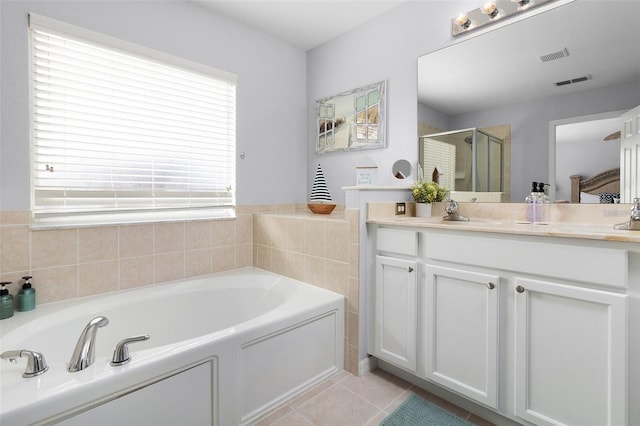 bathroom featuring vanity, visible vents, a stall shower, tile patterned flooring, and a garden tub