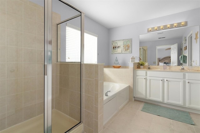 full bathroom featuring tile patterned flooring, a shower stall, a garden tub, and connected bathroom