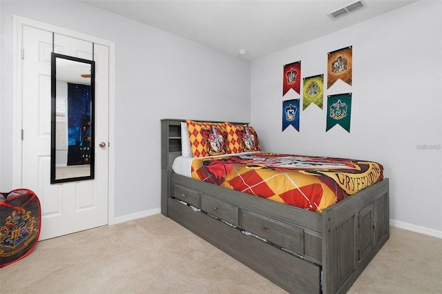 carpeted bedroom featuring baseboards and visible vents