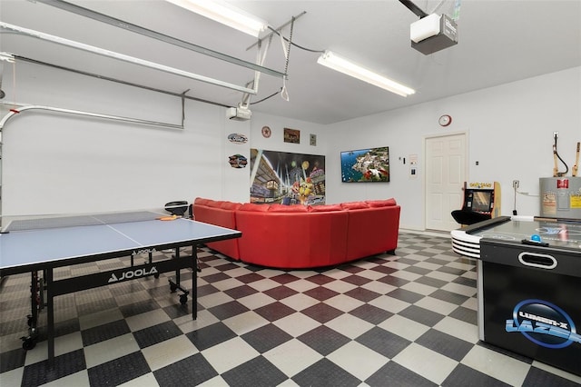 recreation room with water heater and a garage