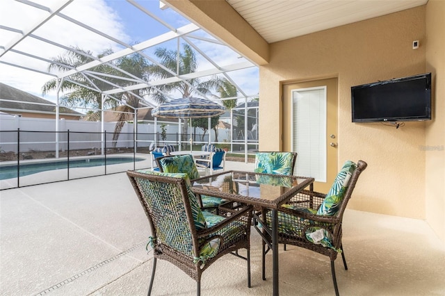 view of patio with a lanai, a fenced in pool, and fence