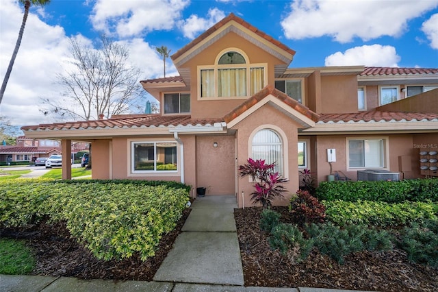 view of front of property with a tile roof and stucco siding