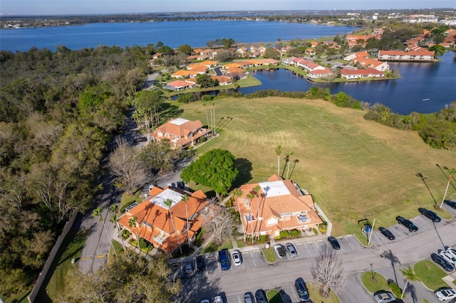 drone / aerial view featuring a water view and a residential view