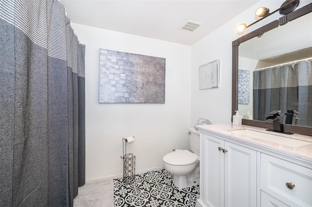 bathroom featuring visible vents, toilet, vanity, baseboards, and tile patterned floors