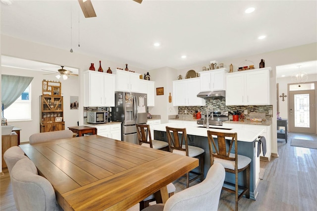 dining space featuring recessed lighting, light wood-type flooring, and ceiling fan