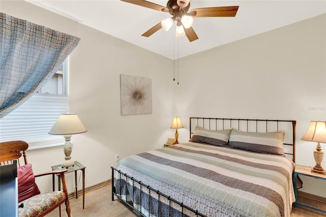 bedroom featuring wood finished floors and a ceiling fan