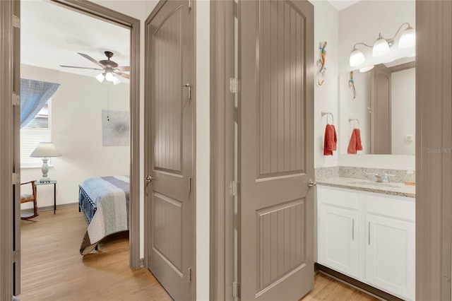 bathroom with vanity, wood finished floors, and ceiling fan