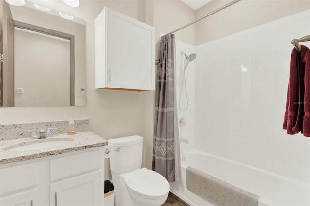 bathroom with shower / bath combo with shower curtain, toilet, and vanity