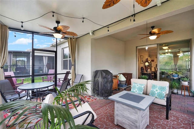 sunroom featuring ceiling fan