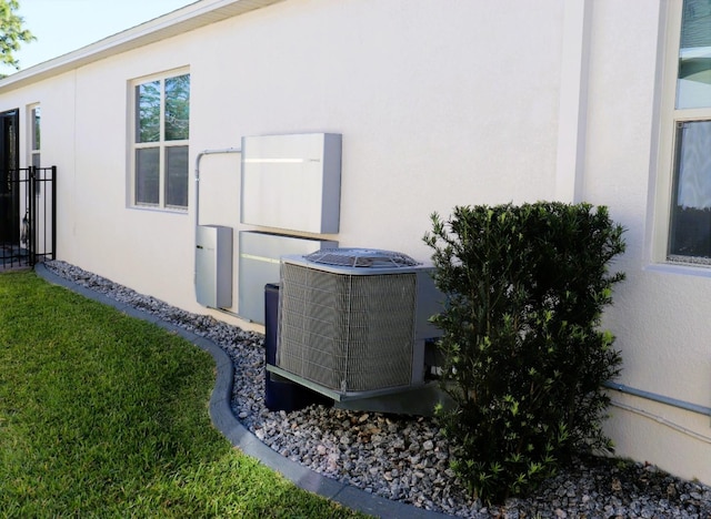 view of property exterior featuring central air condition unit and stucco siding